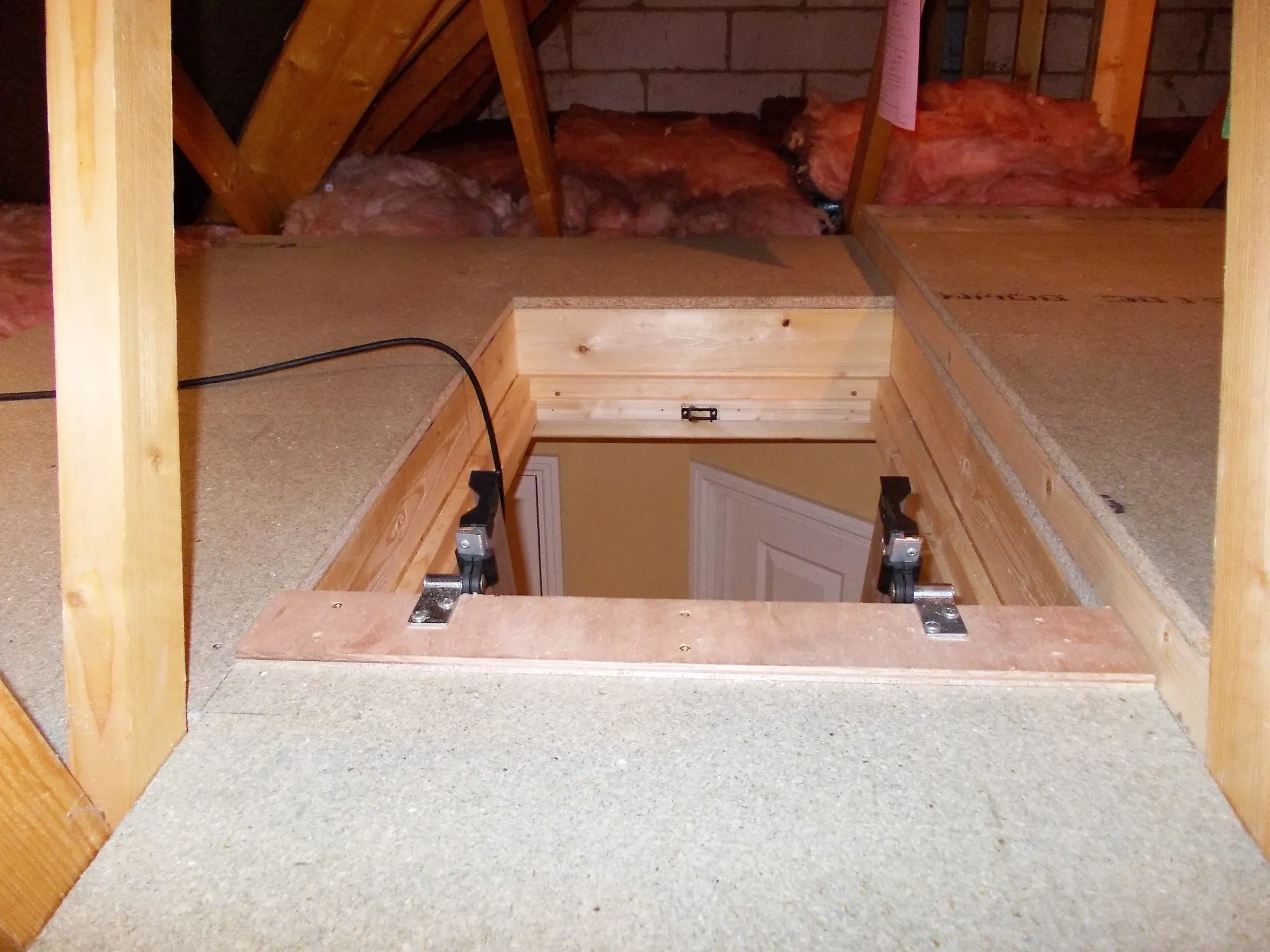 Close-up of dual computer monitors with green coding interfaces in a dark room, highlighting cyber security themes.